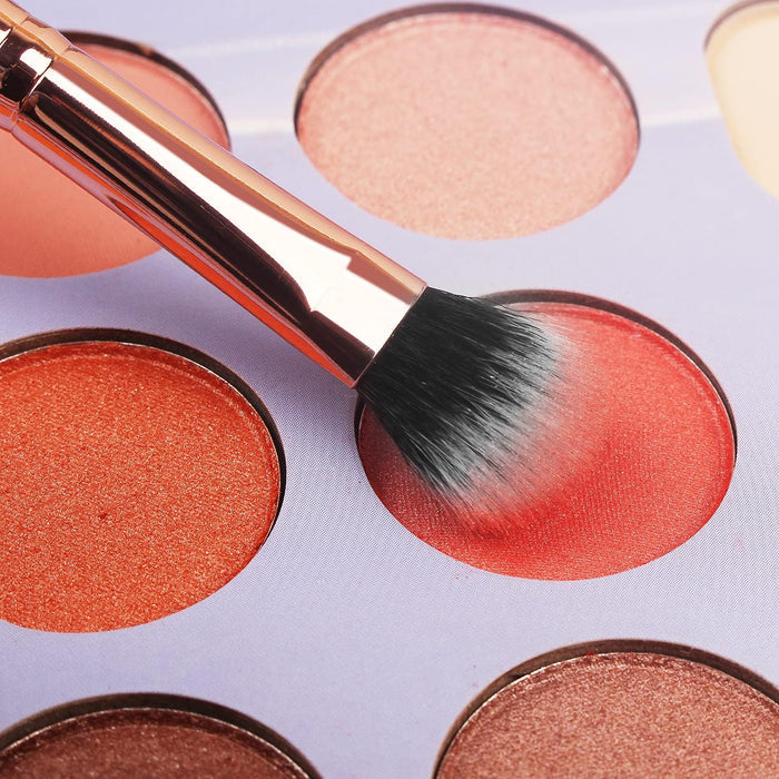 A makeup brush is being used on a palette of eyeshadows from the 16-Piece Makeup Brushes Set Kit with Premium Synthetic Bristles and an Eyebrow Razor