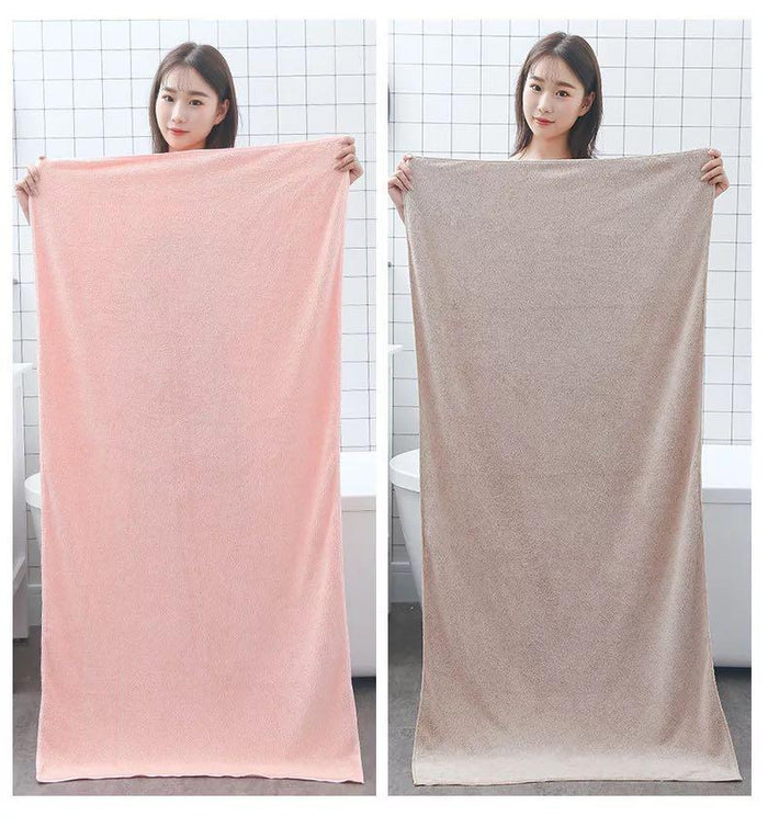 A lady showing a bath towel set for kids and adults
