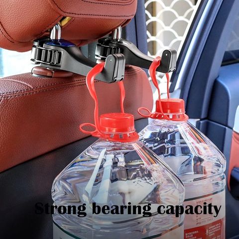 bottles hanging on the Car Headrest Hook Handbag Storage Holder