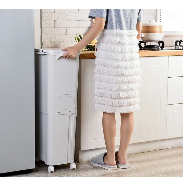 A white kitchen trash can with a lid, suitable for disposing of large garbage in the kitchen