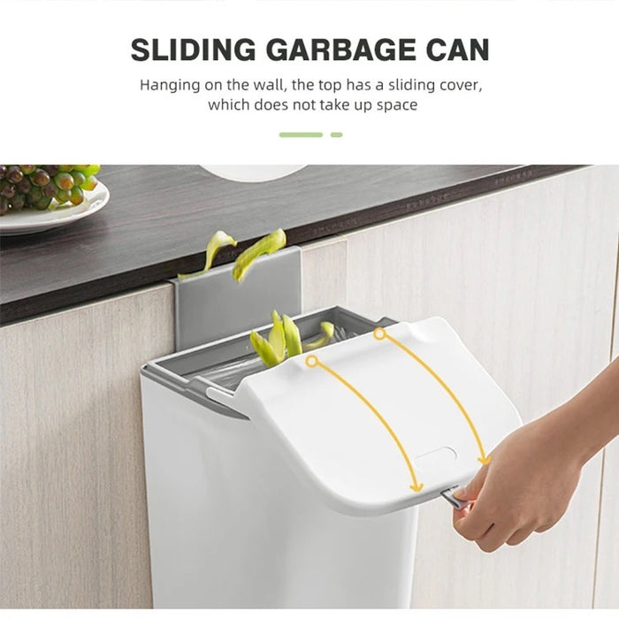 Someone is opening the 9L Trash Can Wall Mounted Hanging Bin for the Kitchen Cabinet Door