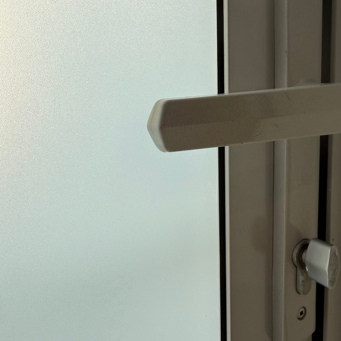 Close-up of a door handle on a glass door
