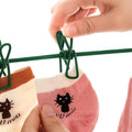A Person is Hanging Socks on Adjustable Clothes Drying Rope.
