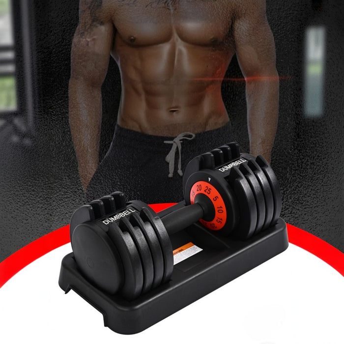 An adjustable dumbbell set is placed on its base. The setting appears to be a gym or workout area.