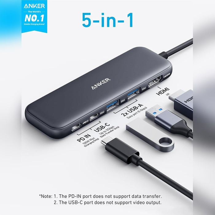 A compact Anker 5-in-1 USB-C hub featuring HDMI 4K, two USB-A ports, a USB-C data port, and a PD-IN port for 100W pass-through charging to expand laptop connectivity.