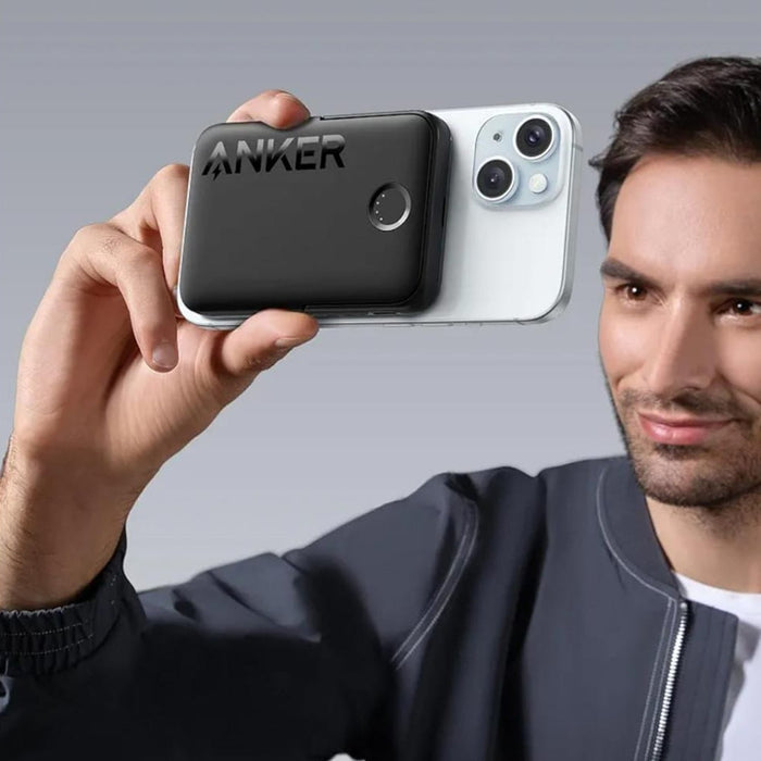 A Person is Holding Anker MagGo 322 Power Bank Connected to his Mobile Phone.