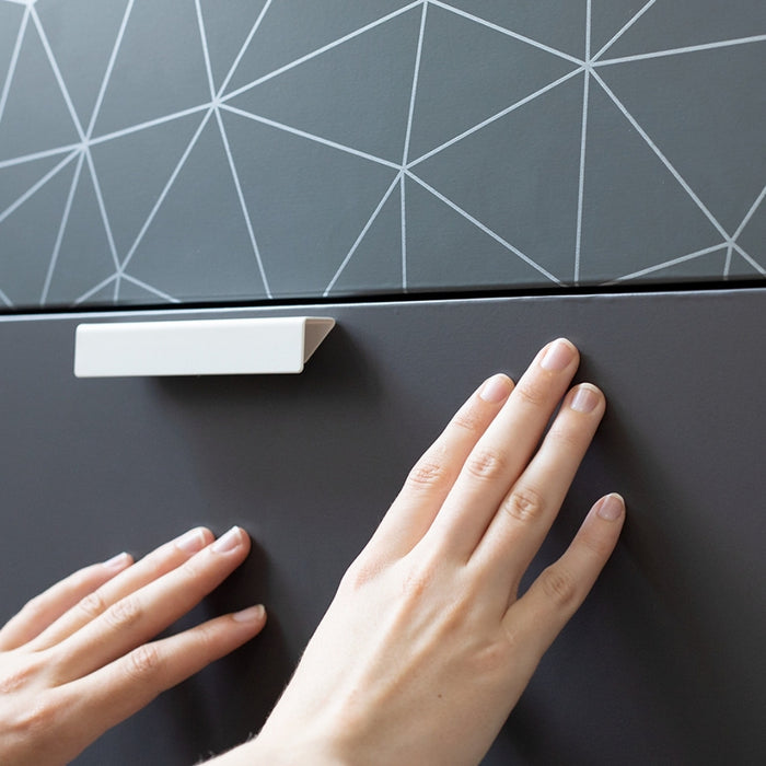 A drawer front vinyl wrapped with anthracite matte adhesive vinyl.