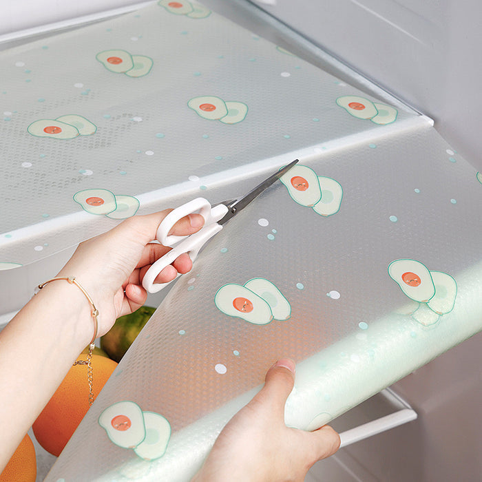 A person using scissors to cut a Anti-Slip Refrigerator Kitchen Cabinet Drawer Shelf Mat Liner Sheets