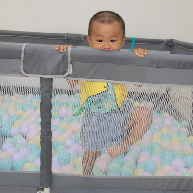 Baby in a Baby Playpen.