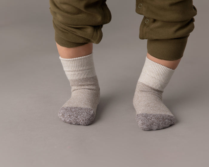 Caelan cotton crew socks: child standing in beige color-block crew socks. Squid Socks, the brand seen on Shark Tank.