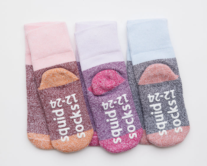 Chelsea cotton crew socks: three cotton crew socks showing contrasting heels and branded soles. Squid Socks, the brand seen on Shark Tank.