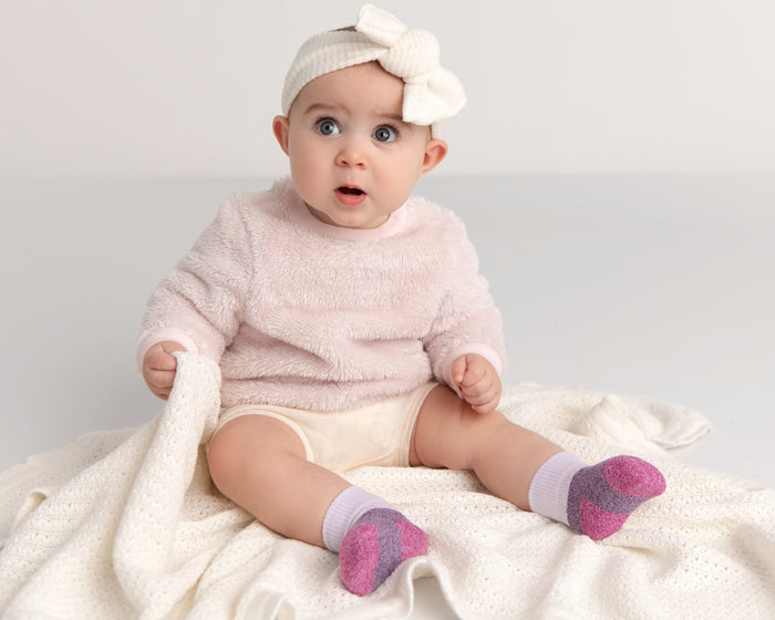 Chelsea cotton crew socks: baby seated wearing pastel color-block crew socks. Squid Socks, the brand seen on Shark Tank.