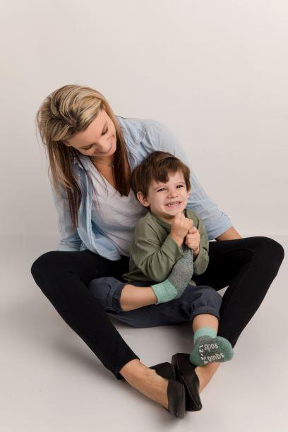 Chris cotton crew socks: adult holding a child wearing mint-cuff crew socks. Squid Socks, the brand seen on Shark Tank.