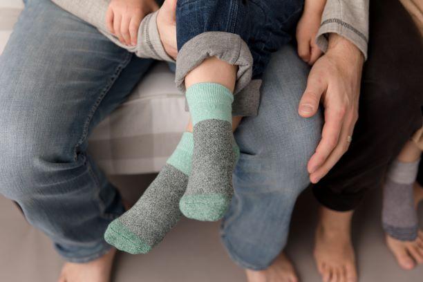 Chris cotton crew socks: child wearing mint-cuff crew socks while seated with an adult. Squid Socks, the brand seen on Shark Tank.