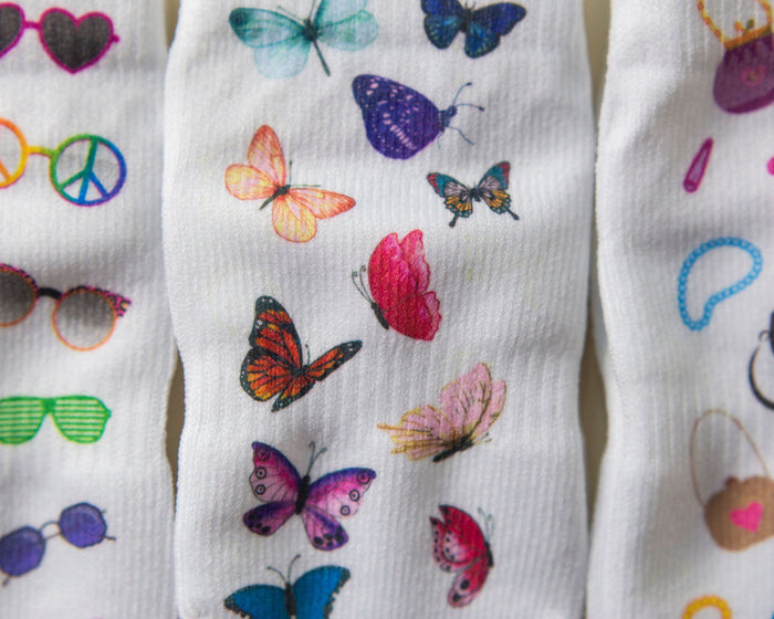 Caitlyn kids socks: close-up of colorful sunglasses and butterfly prints. Squid Socks, the brand seen on Shark Tank.