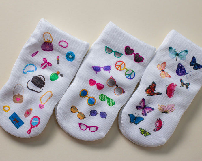 Caitlyn kids socks: three white socks with fashion, sunglasses and butterfly prints. Squid Socks, the brand seen on Shark Tank.