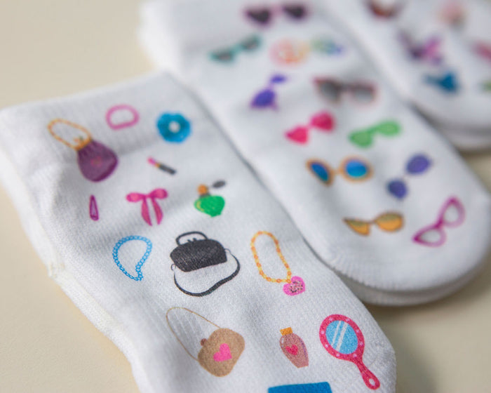 Caitlyn kids socks: close-up of fashion accessories printed on white socks. Squid Socks, the brand seen on Shark Tank.