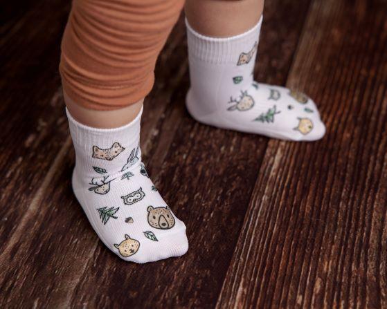 Camping kids socks: child wearing woodland animal-print socks. Squid Socks, the brand seen on Shark Tank.