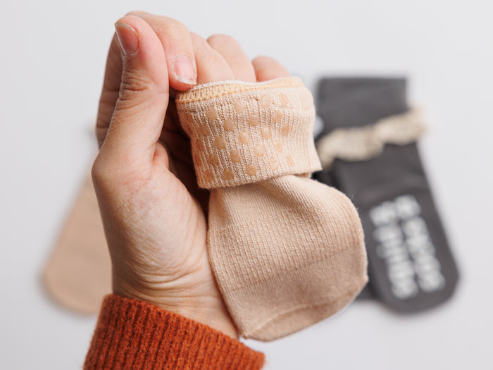 Candace kids socks: hand holding a beige sock with its cuff folded outward. Squid Socks, the brand seen on Shark Tank.