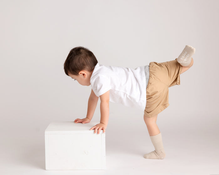 Caramel kids socks: child balancing beside a block in toffee socks. Squid Socks, the brand seen on Shark Tank.