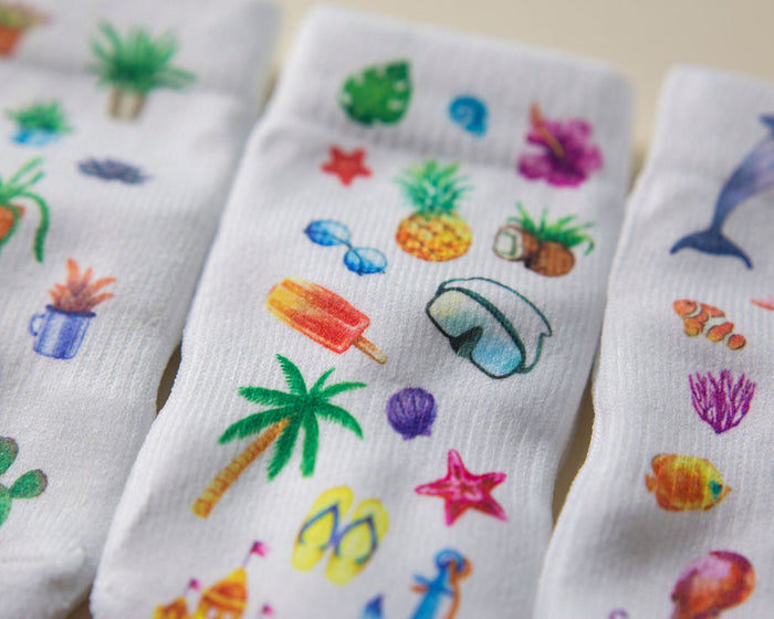 Caribbean kids socks: close-up of tropical fruit, palm trees and ocean prints. Squid Socks, the brand seen on Shark Tank.