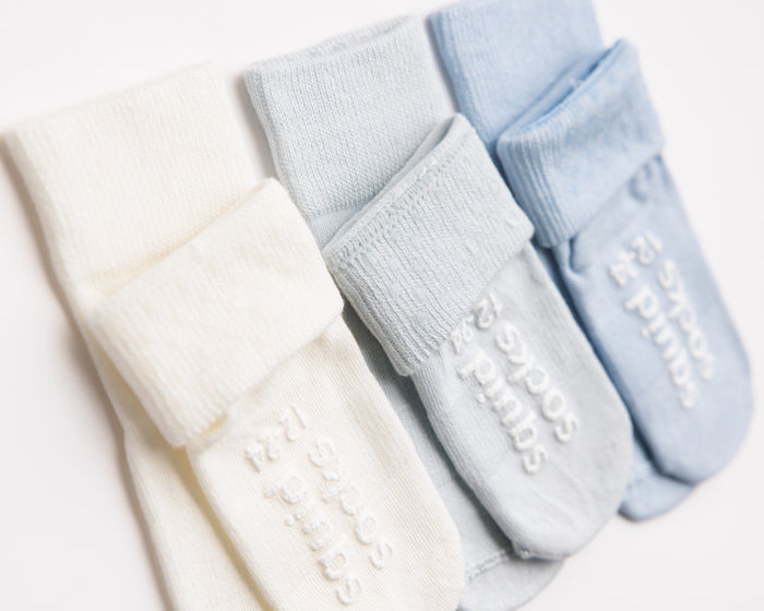 Casen kids socks: ivory and pale blue socks with folded cuffs and branded soles. Squid Socks, the brand seen on Shark Tank.