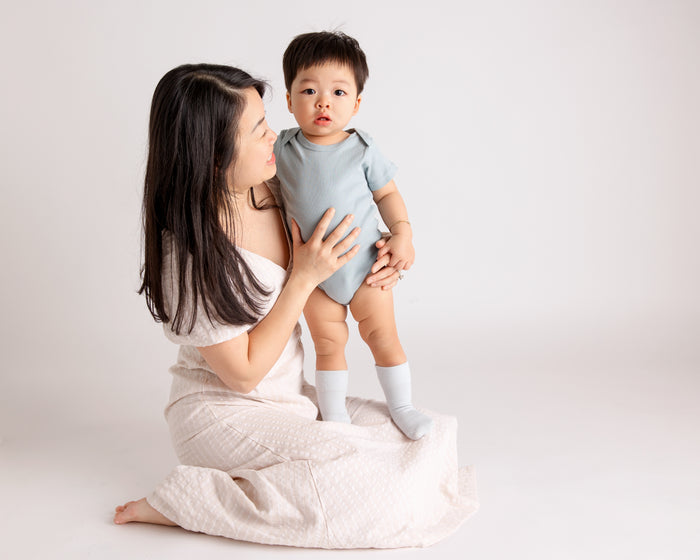 Casen kids socks: adult holding a child wearing pale blue socks. Squid Socks, the brand seen on Shark Tank.