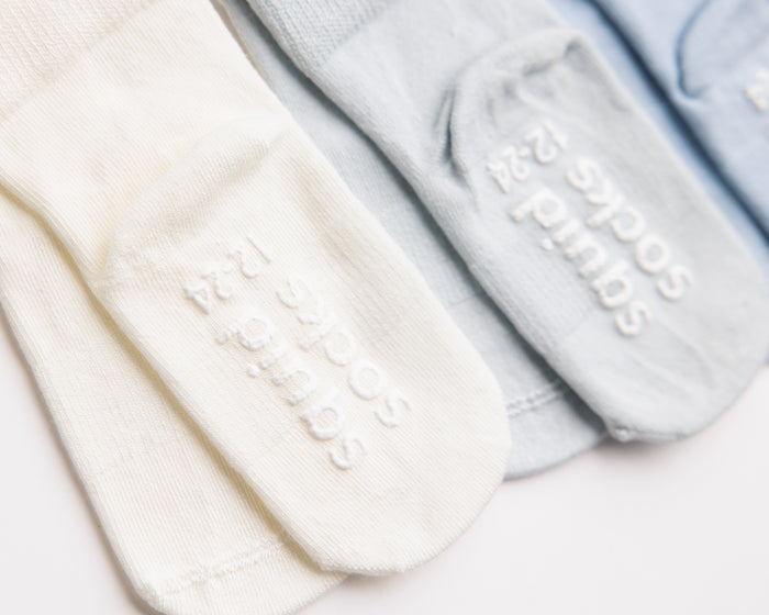 Casen kids socks: close-up of ivory and blue sole grips. Squid Socks, the brand seen on Shark Tank.