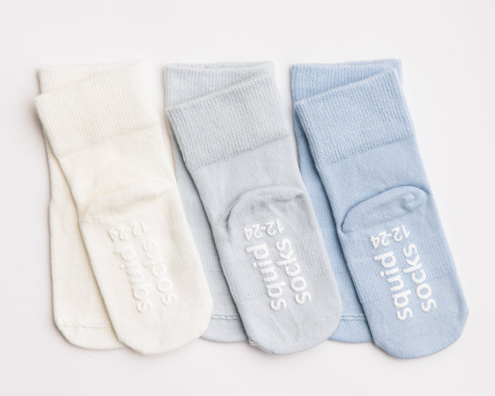 Casen kids socks: three ivory and pale blue socks showing branded soles. Squid Socks, the brand seen on Shark Tank.