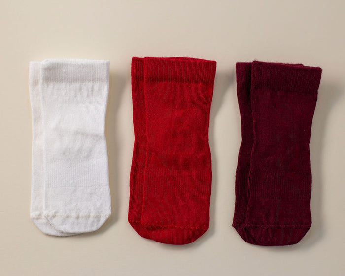 Channing kids socks: three red, cream and wine-colored socks laid flat. Squid Socks, the brand seen on Shark Tank.