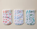Chloe kids socks: three socks laid flat with floral, rainbow and foliage prints. Squid Socks, the brand seen on Shark Tank.