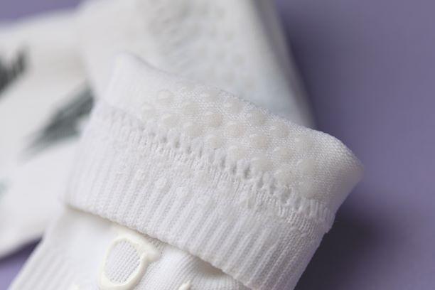 Chloe kids socks: close-up of silicone grip dots inside a white cuff. Squid Socks, the brand seen on Shark Tank.