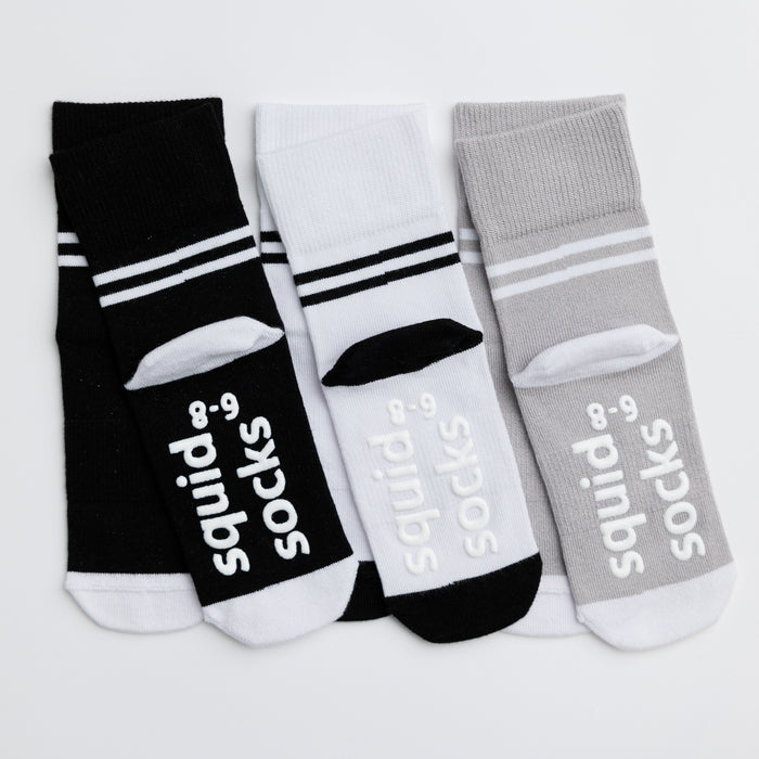 City kids socks: three striped-cuff socks showing branded sole grips. Squid Socks, the brand seen on Shark Tank.