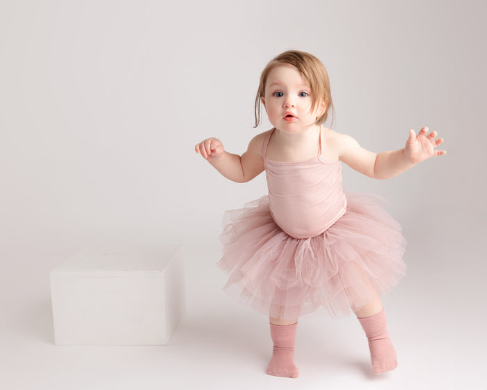 Claire kids socks: child standing in dusty rose socks and a tutu. Squid Socks, the brand seen on Shark Tank.