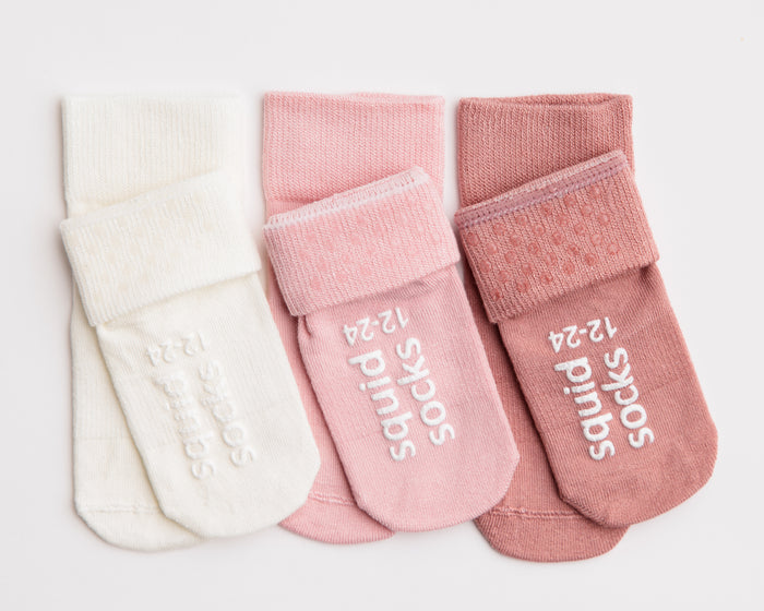 Claire kids socks: ivory, pink and rose socks showing cuff dots and sole grips. Squid Socks, the brand seen on Shark Tank.