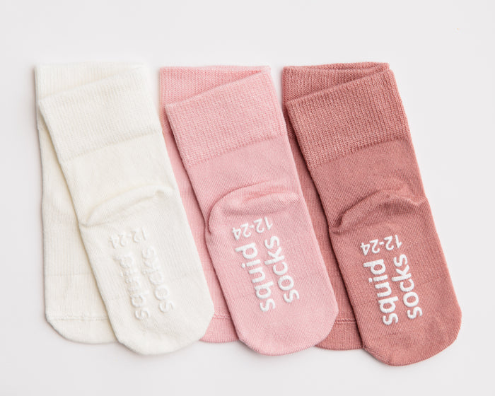 Claire kids socks: three soft-toned socks showing branded soles. Squid Socks, the brand seen on Shark Tank.