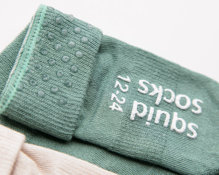 Coastal kids socks: close-up of green cuff dots and sole grips. Squid Socks, the brand seen on Shark Tank.