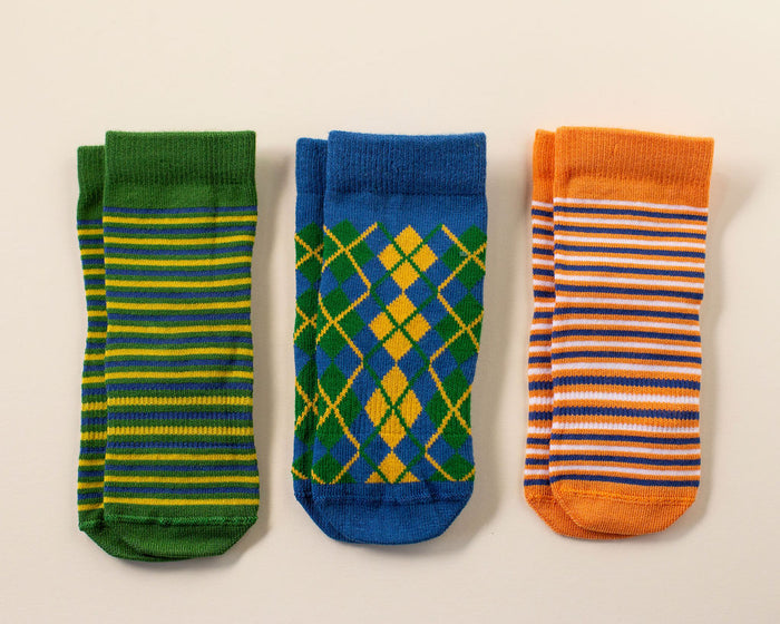 Colin kids socks: three socks in green stripes, blue argyle and orange stripes. Squid Socks, the brand seen on Shark Tank.