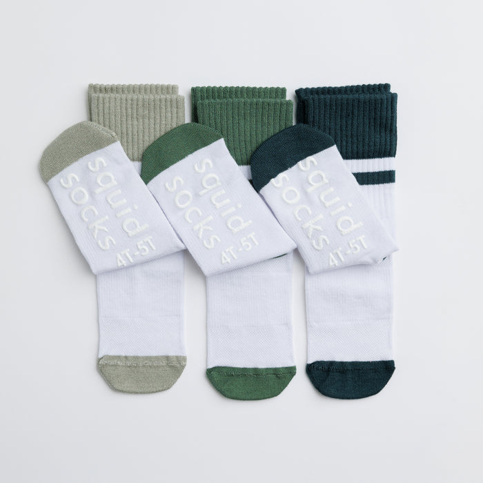 Cooper kids socks: white socks with green-toned cuffs folded outward. Squid Socks, the brand seen on Shark Tank.
