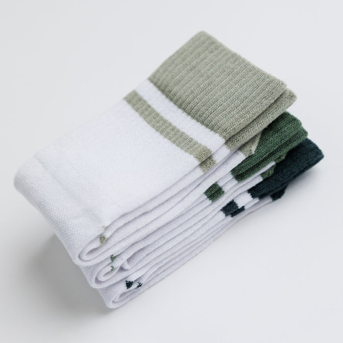 Cooper kids socks: stack of white socks with green-toned cuffs. Squid Socks, the brand seen on Shark Tank.