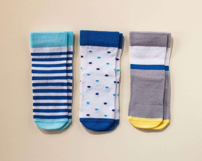 Cruz kids socks: blue striped, dotted and gray color-block socks laid flat. Squid Socks, the brand seen on Shark Tank.