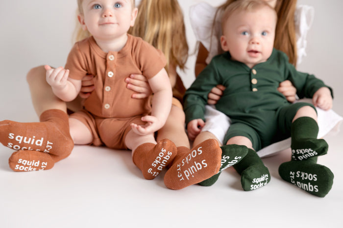 Cypress kids socks: children seated in cognac and dark green socks. Squid Socks, the brand seen on Shark Tank.