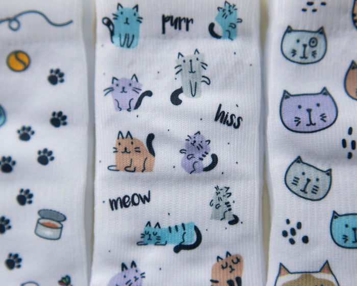 Meow kids socks: close-up of cats, paw prints and cat toys. Squid Socks, the brand seen on Shark Tank.