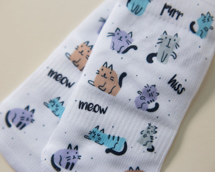 Meow kids socks: white socks with colorful cats and meow lettering. Squid Socks, the brand seen on Shark Tank.