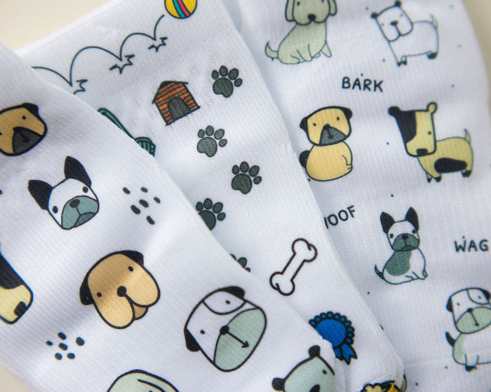 Woof kids socks: close-up of dog faces, paw prints and dog toys. Squid Socks, the brand seen on Shark Tank.