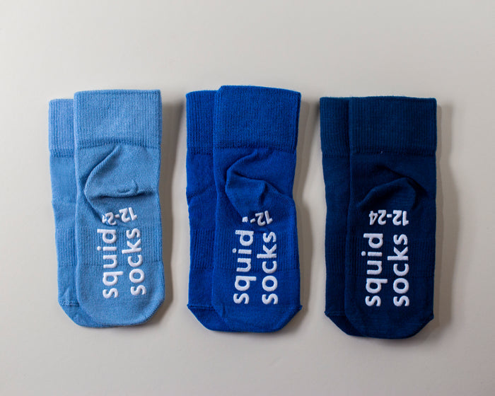 Colby Delicate kids socks: three blue socks showing branded sole grips. Squid Socks, the brand seen on Shark Tank.