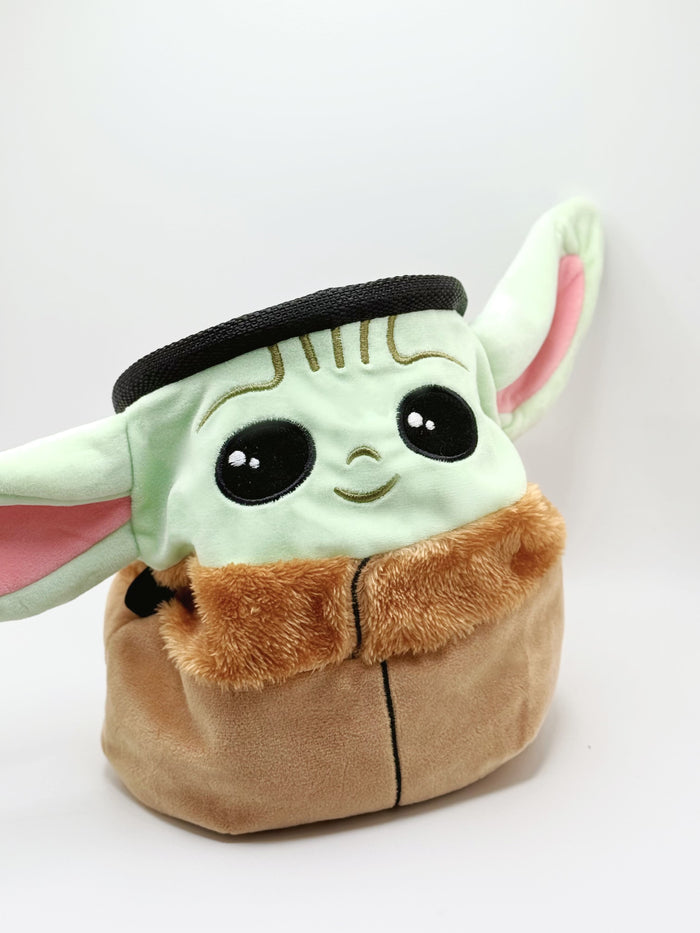 A cute anime plush chalk bag by Fatworm featuring the adorable Baby Yoda. This functional and fluffy green space baby accessory is handmade for bouldering and climbing for rock climbing, offering a long-durable design that makes the perfect climbing gift for a climber.