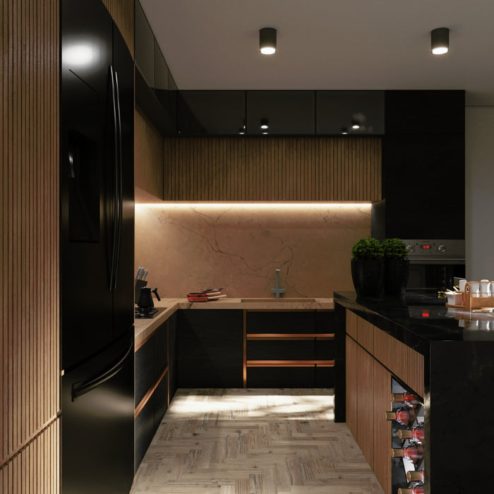 A modern kitchen interior featuring black glossy adhesive vinyl on the kitchen cabinets and countertops.