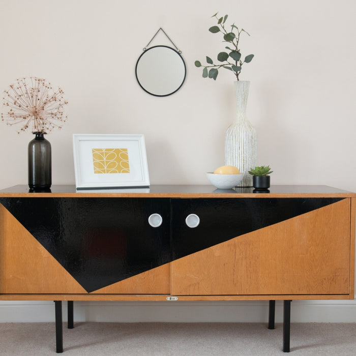 A unit with a triangle black glossy adhesive vinyl on the front with accessories on top.
