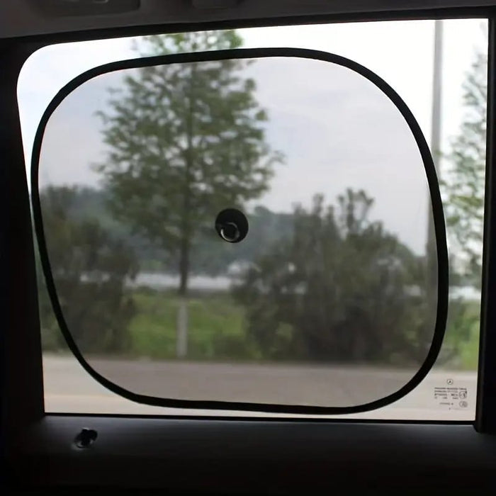 A Car Sun Shade is Fixed On Car Window.